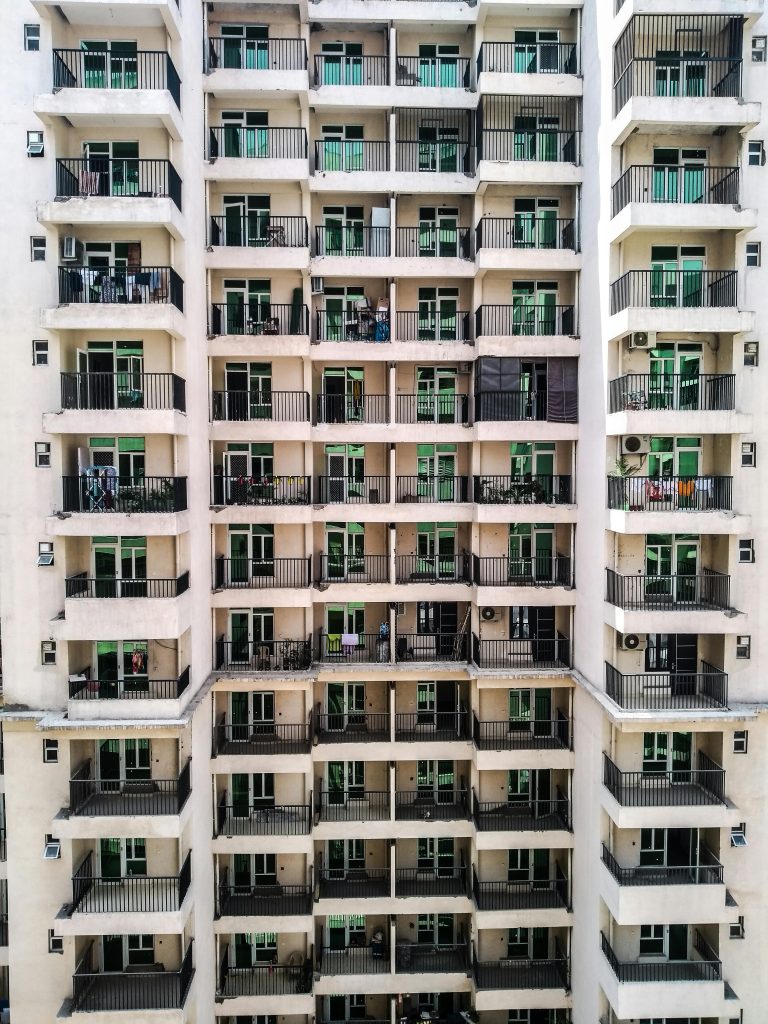 Elevated view of a contemporary multi-storey apartment building featuring numerous balconies.